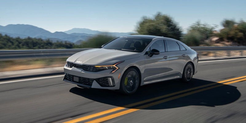 Overhead view of a grey Kia driving on an open highway