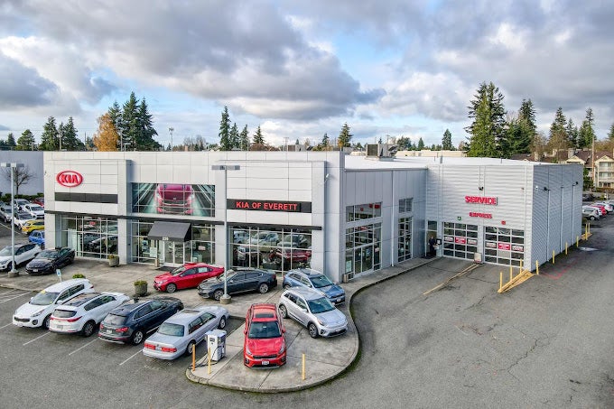 Aerial view of a Kia car dealership building with a showroom on the left