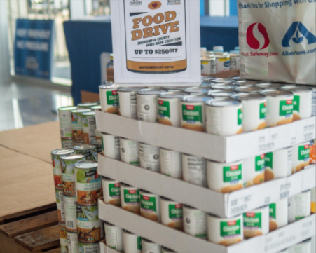 Stacks of canned food with a Snohomish County Food Bank Coalition sign